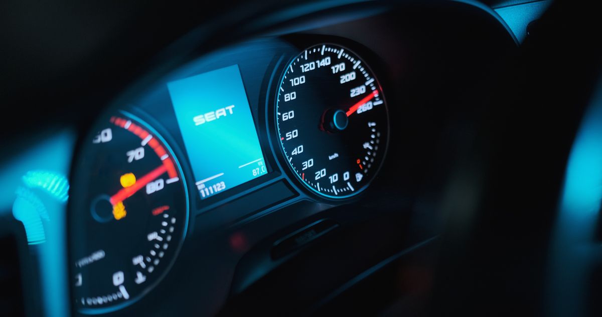 Vibrant close-up of a car speedometer showing how fiber optic lighting illuminates automotive instrument panels