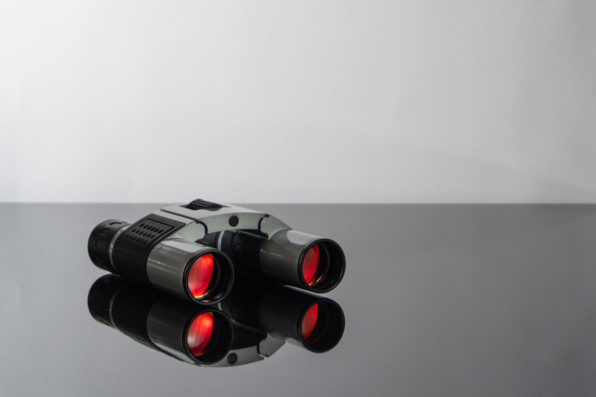 Optical instruments in close-up: modern binoculars with red-coated lenses, a common image-enhancement optical instrument