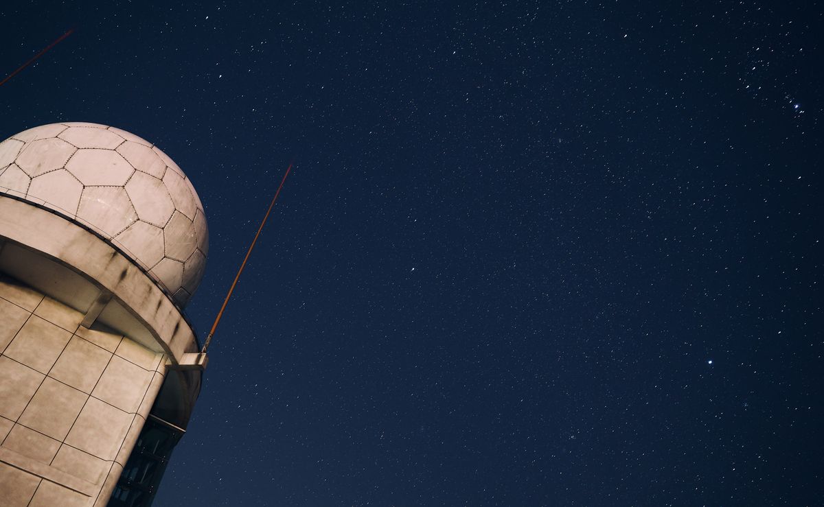 Observatory dome under a starry night sky with Milky Way visible
