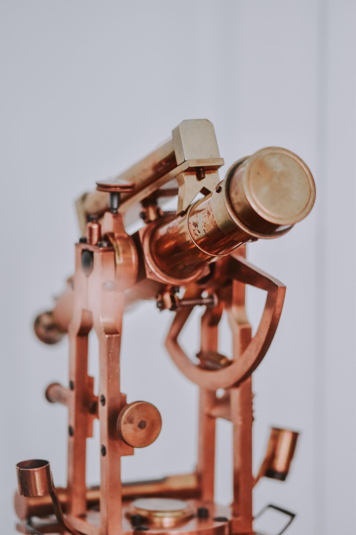 What is the opposite of a telescope? A vintage brass telescope in close-up — its counterpart is the microscope