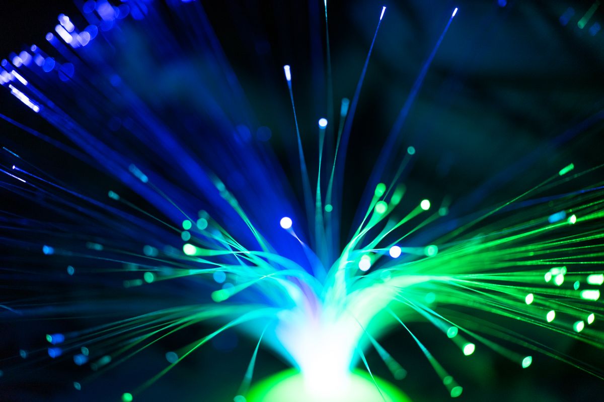 Optical fibre invention legacy: close-up of illuminated fiber optic lights in blue and green representing Colladon's early light-guiding experiments