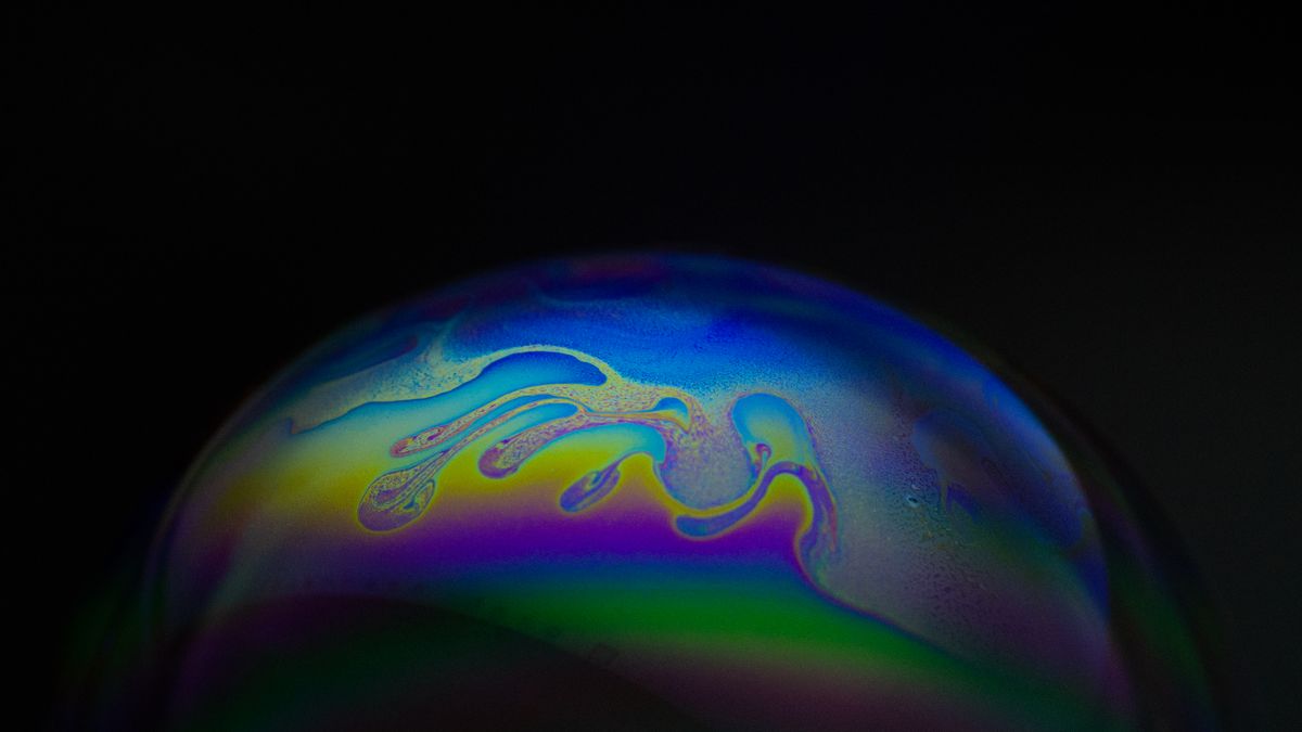 Interference patterns in thin film showing rainbow colours on a soap bubble surface
