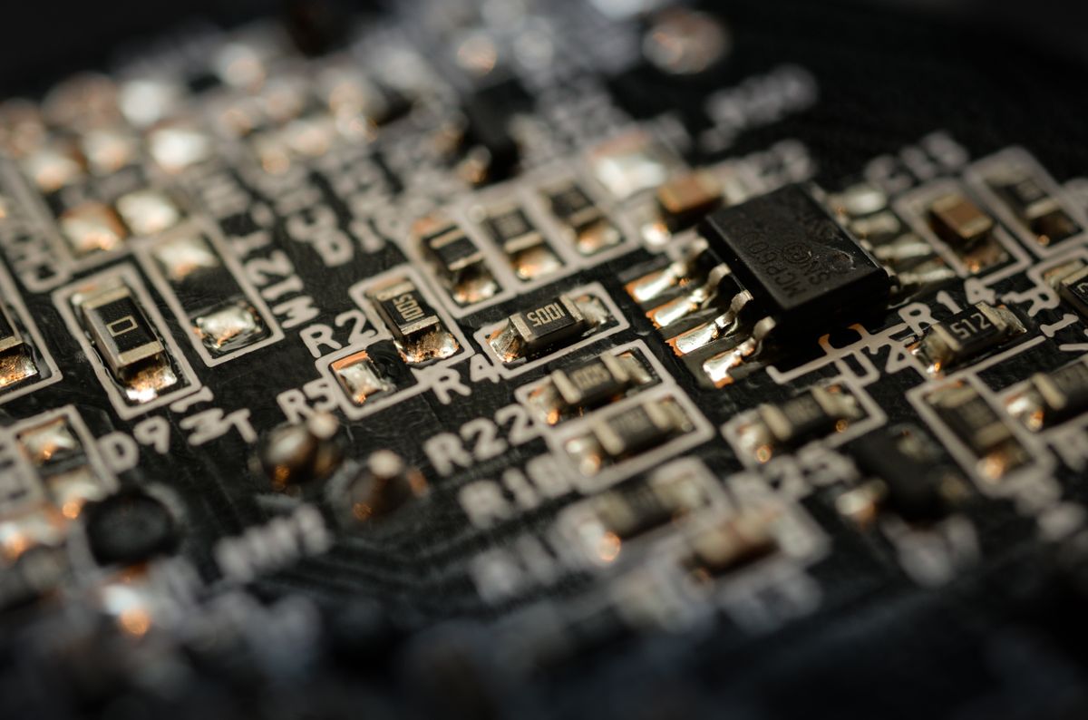 Detailed macro shot of a microchip circuit board, representing the semiconductor technology behind diode lasers