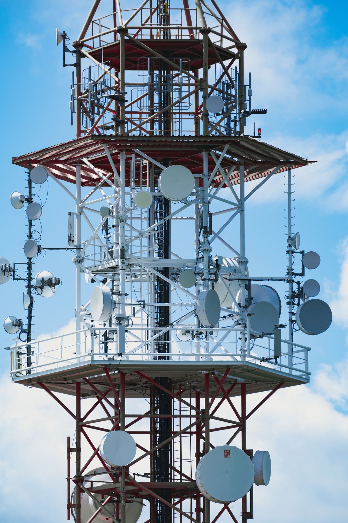 Telecommunication radio tower against a clear sky representing the wireless extension of fiber optic network infrastructure