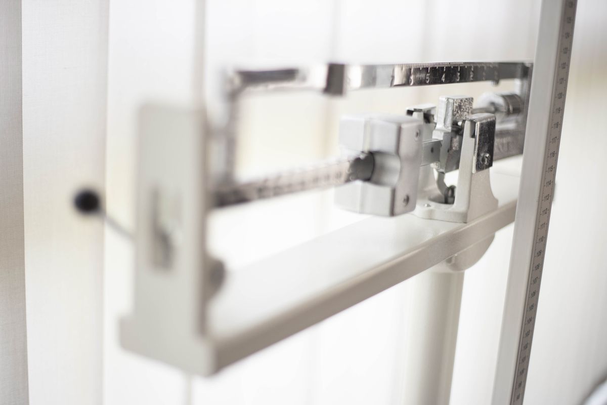 A balance scale, a reminder you cannot weigh a beam — so is light matter? No