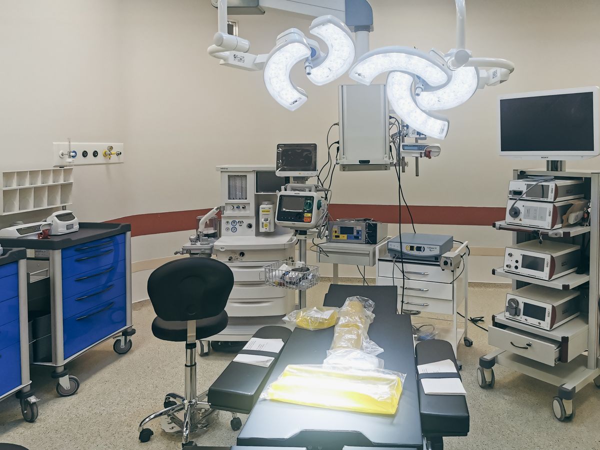 what are fiber optic cables used for surgeon performing endoscopic surgery with fiber optic medical equipment in hospital operating room