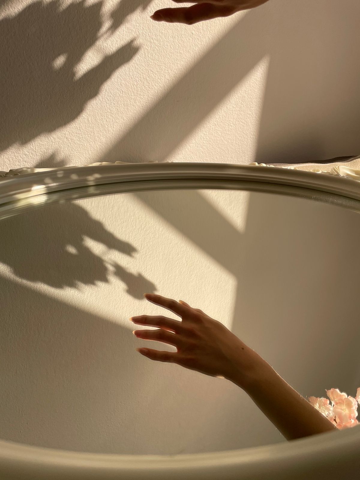 Hand reflected in a mirror showing what is reflective light from a smooth specular surface