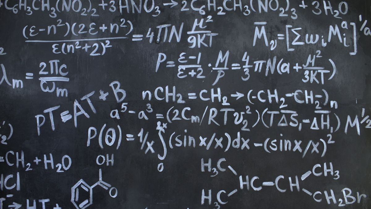 A close-up view of intricate physics and mathematical formulas written on a chalkboard, similar to what you might sketch when learning concave mirror ray diagram rules