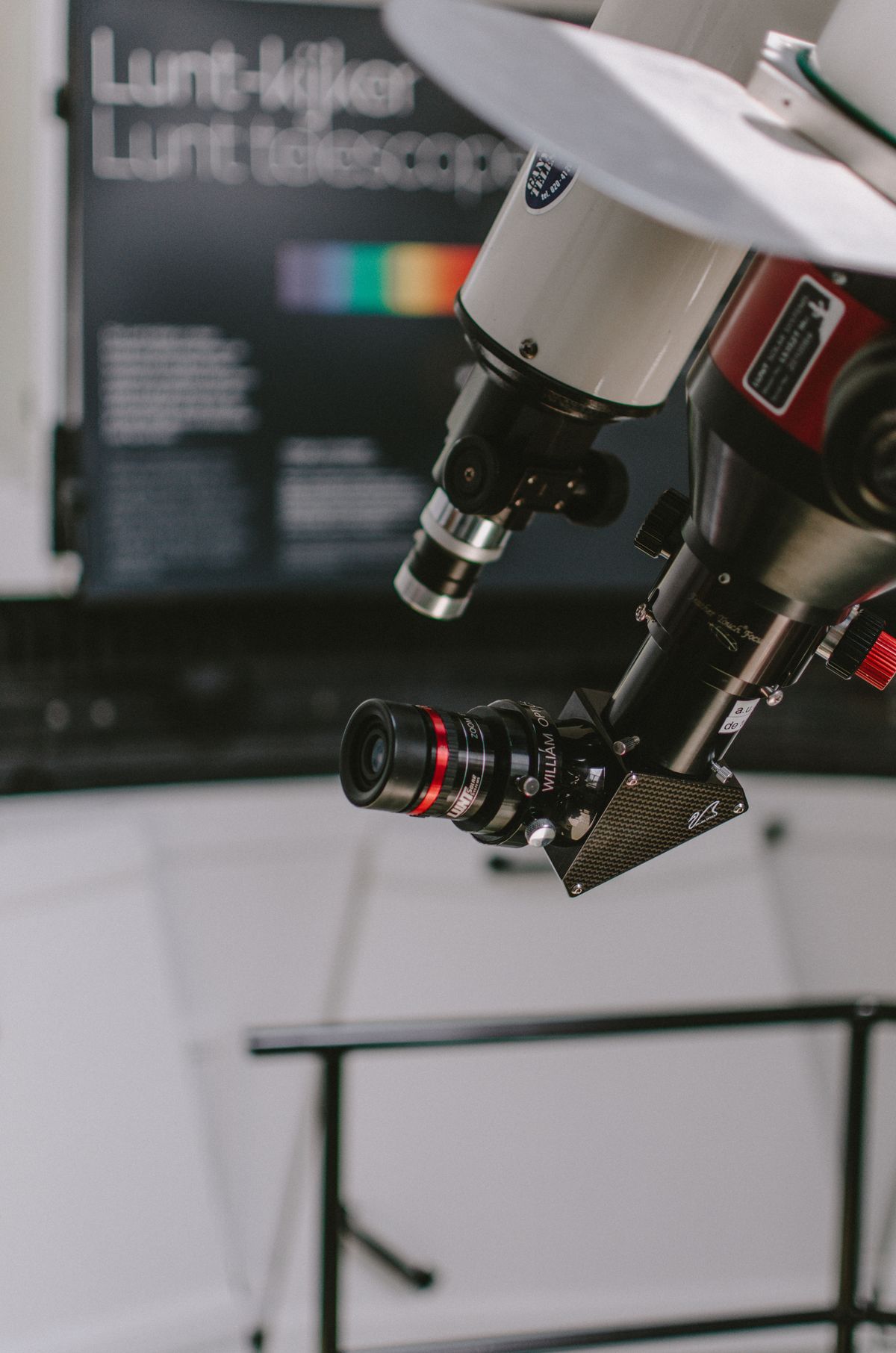 Close-up of a telescope fitted with a camera in a modern laboratory showing precision optics
