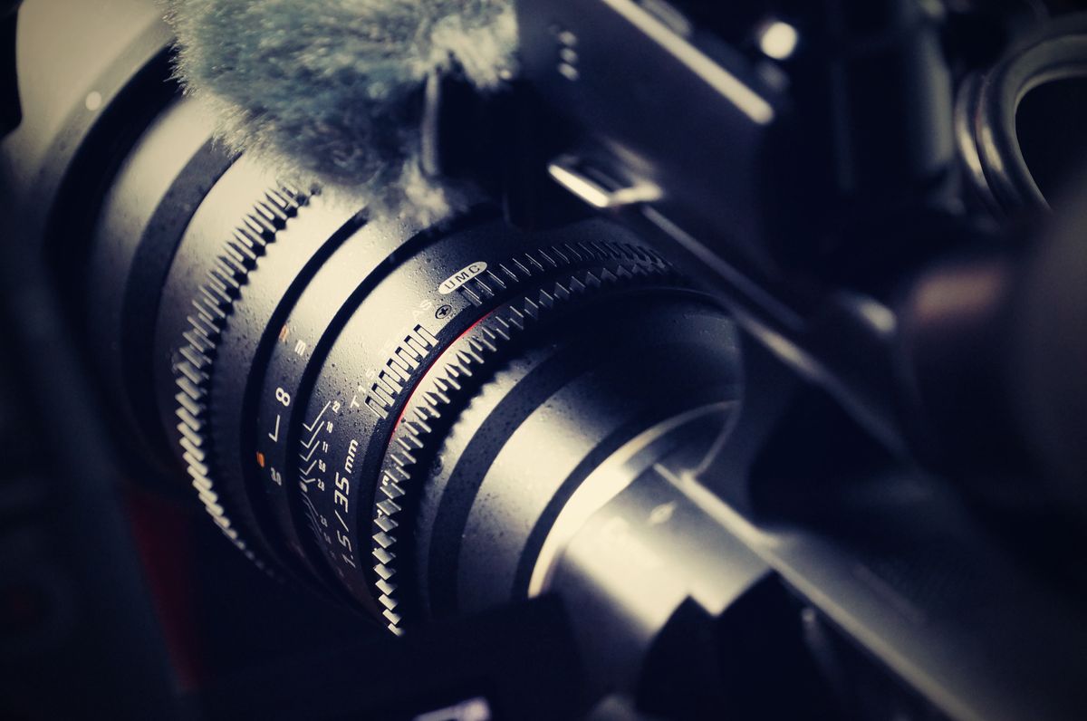 Close-up of a camera lens showing multiple glass elements that use refraction to form sharp images