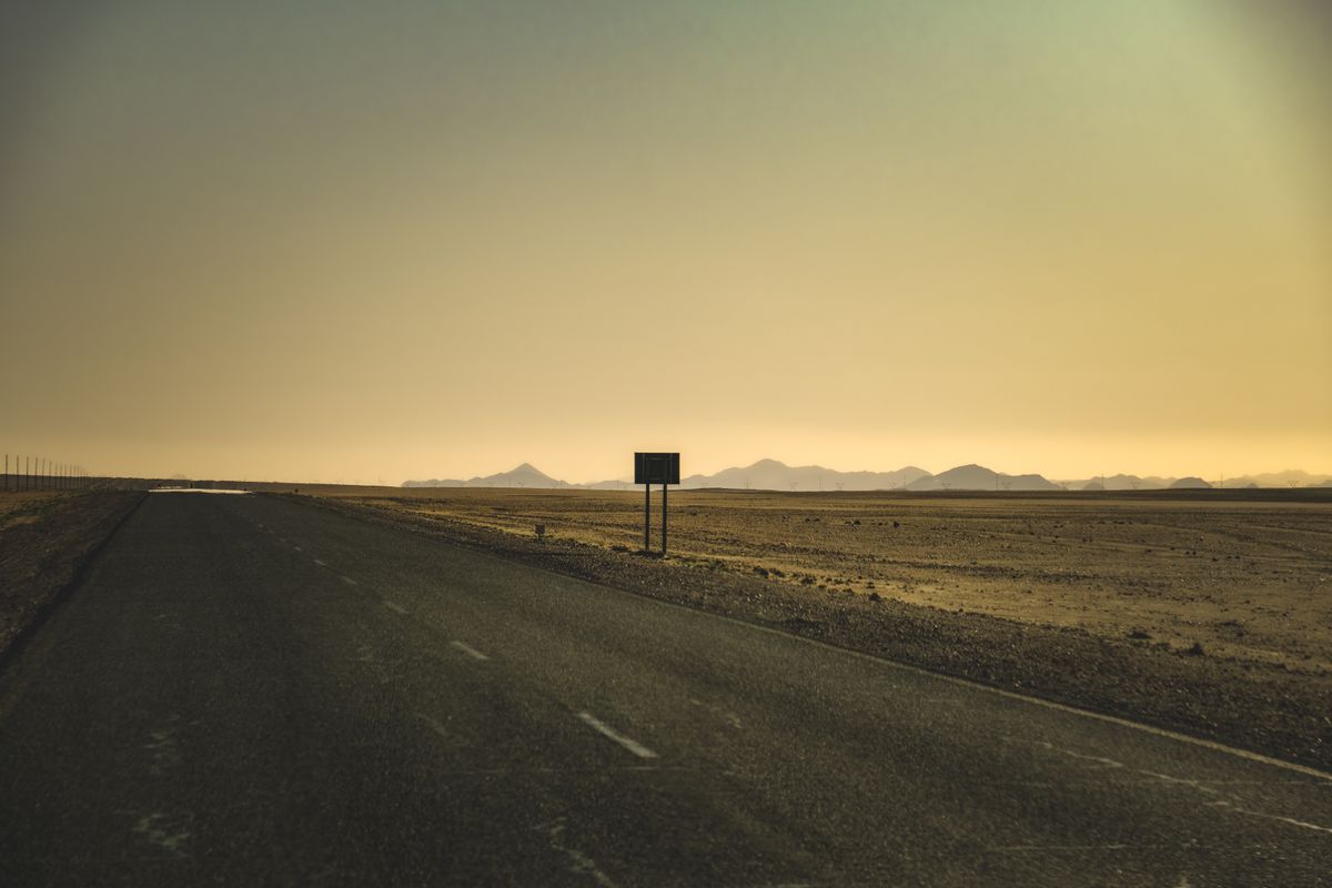 An empty road stretching through the desert, the classic setting for a mirage on road