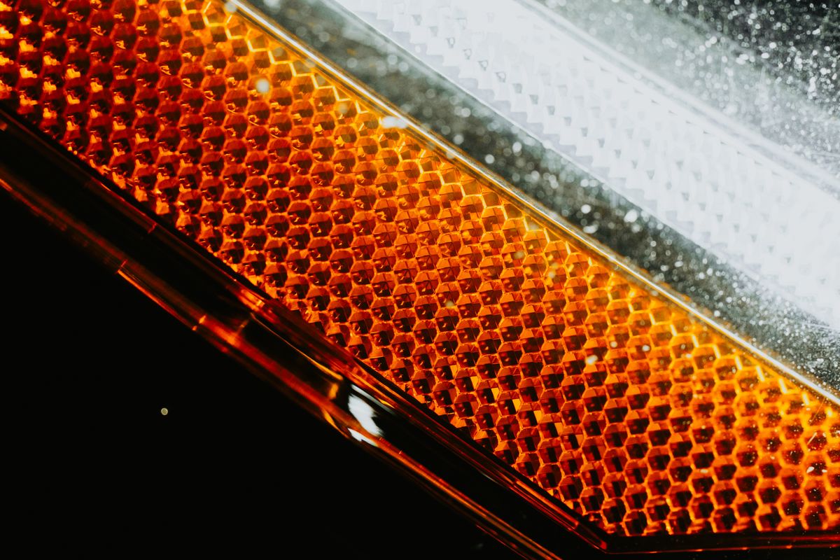 Car headlight using a concave lens to spread light into a wide, even beam
