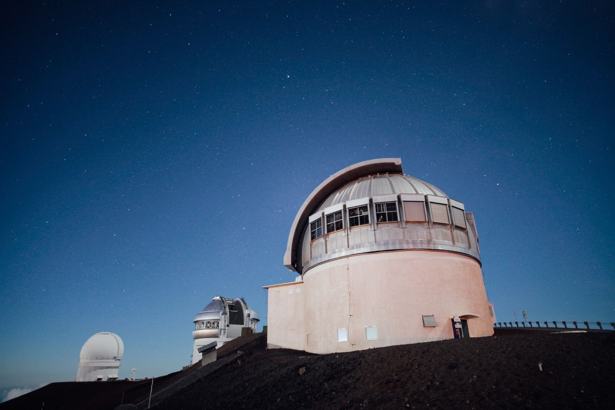 Radio telescope observatory at night, showing how astronomers observe gravitational lensing effects across the universe