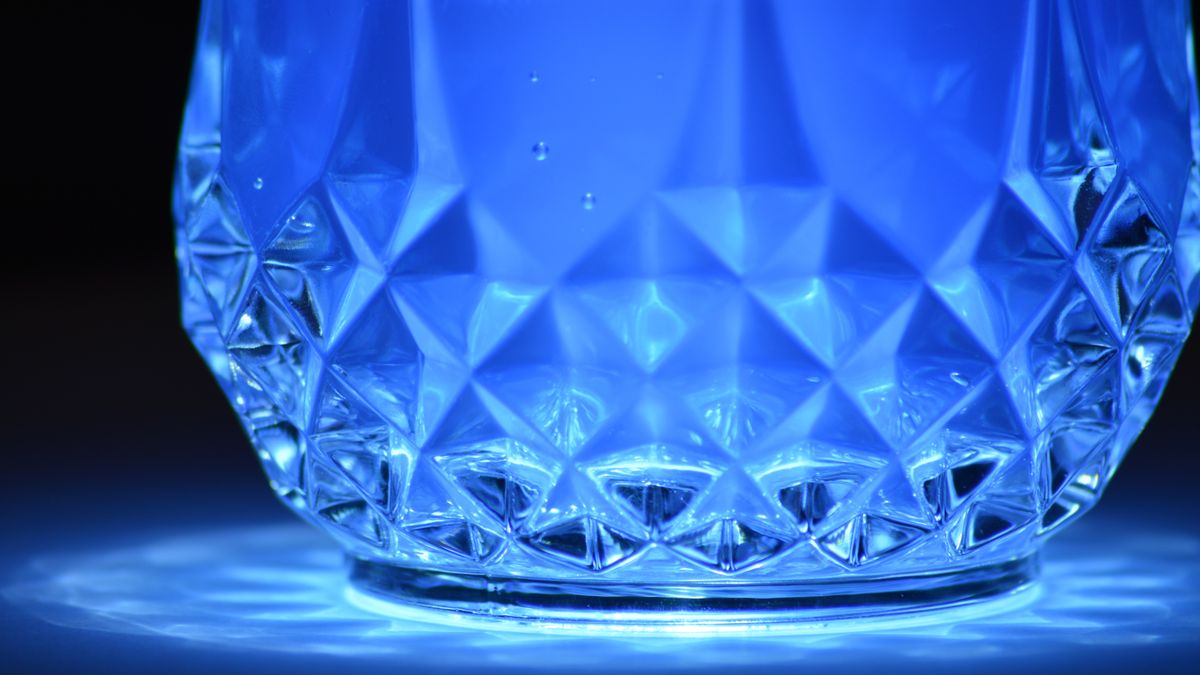 Blue illuminated crystal glass showing intricate refraction patterns