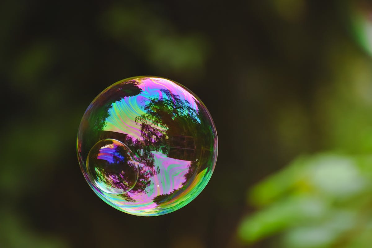 An iridescent soap bubble showing interference colours in its thin film