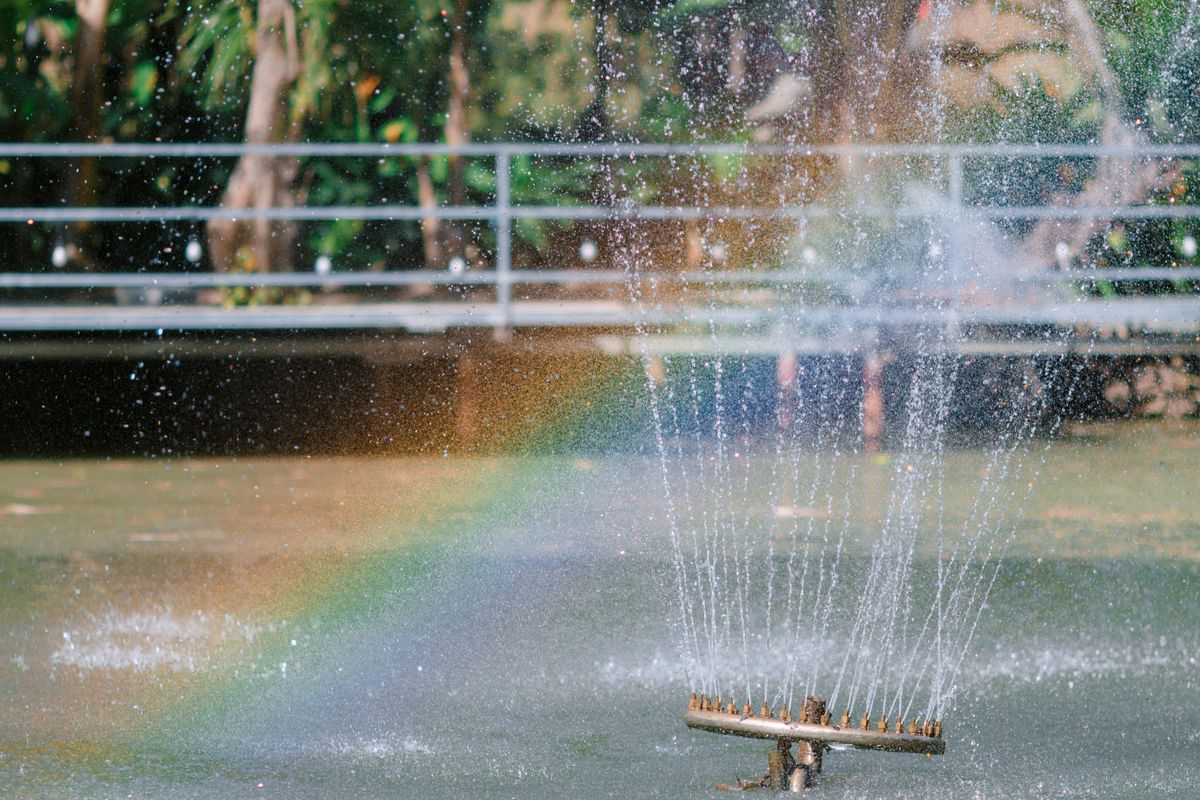Rainbow visible in a fountain spray, showing how water mist can create a full circle rainbow effect