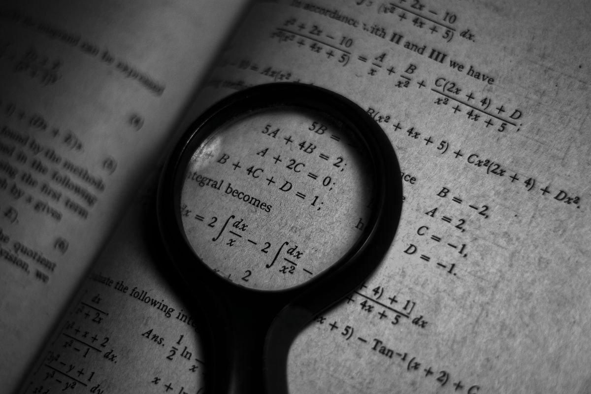 A magnifying glass over mathematics — the kind of optics the optics lens maker formula describes