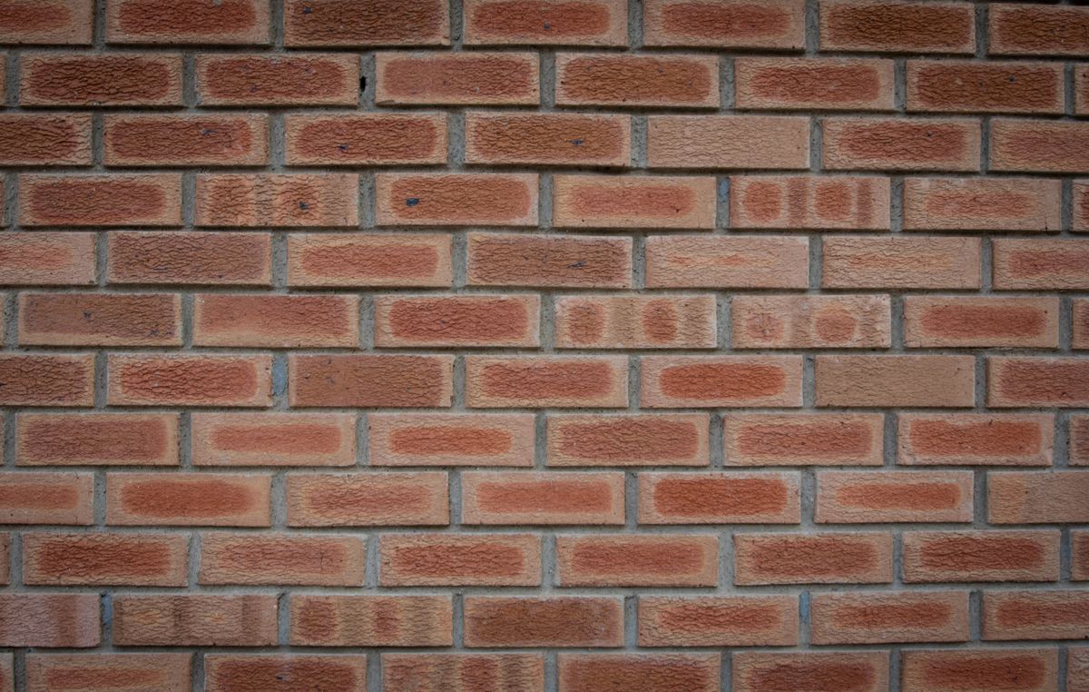 Detailed texture of a red brick wall, a rough surface that produces diffuse reflection of light and demonstrates reflection physics waves