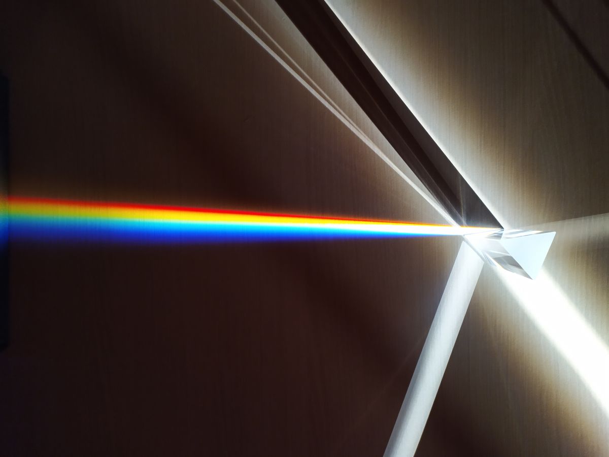 White light split into a spectrum by a glass prism, showing the types of light