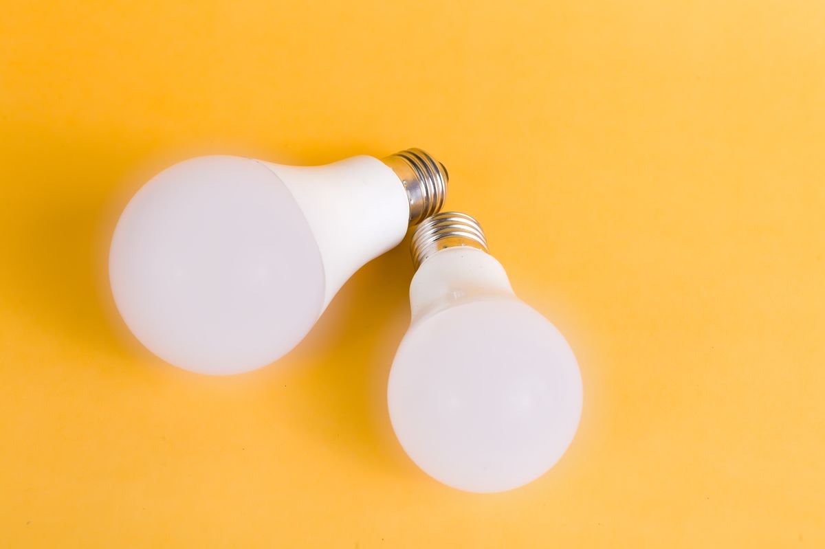 Two energy-efficient LED light bulbs on a bright background