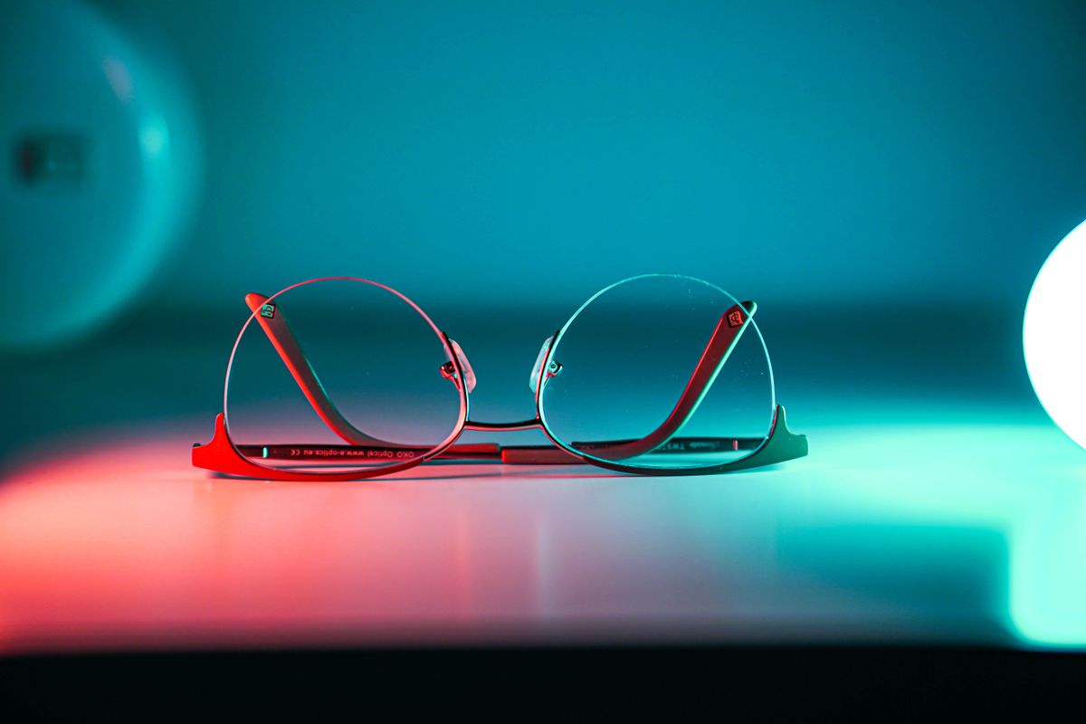 Eyeglass lenses on a reflective surface showing how lenses use refraction to focus light