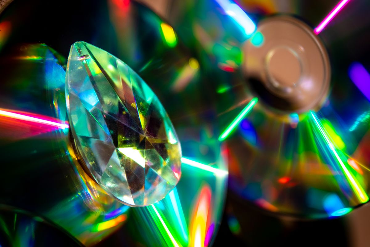 Compact disc showing rainbow diffraction from its grooves, a clear example of refraction vs diffraction in everyday life