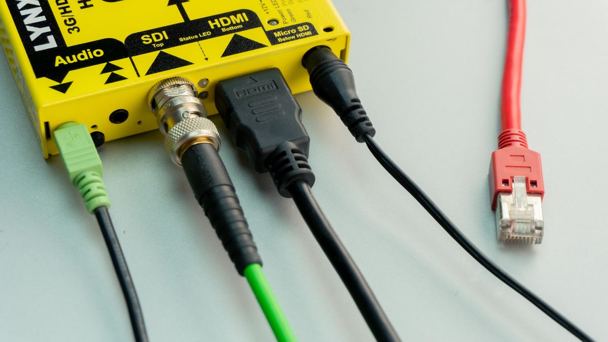 Different audio and video cables including HDMI Ethernet and audio connected to a device showing connectivity options