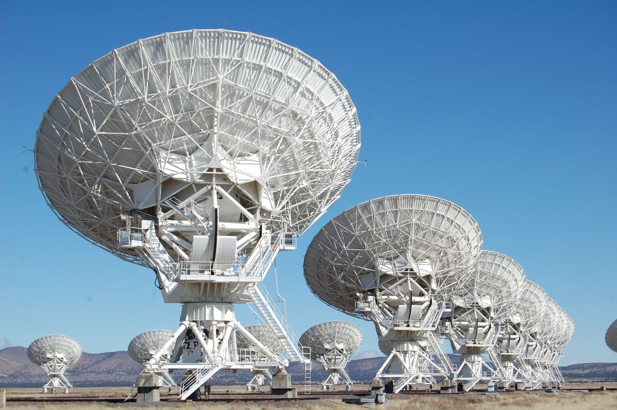 A row of radio telescopes against the sky, collecting the longest type of light