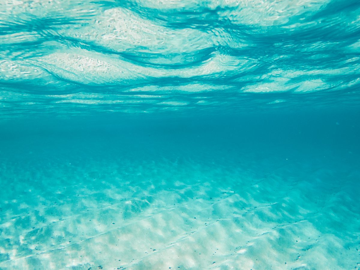 Clear turquoise underwater view showing the effect of refraction of light in water
