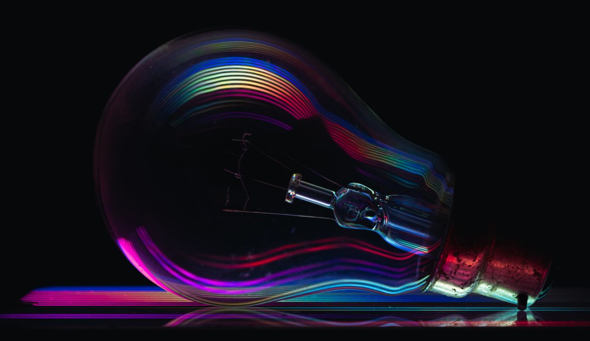 Optical density formula: colorful light spectrum through a prism showing how different wavelengths are absorbed or transmitted differently by materials