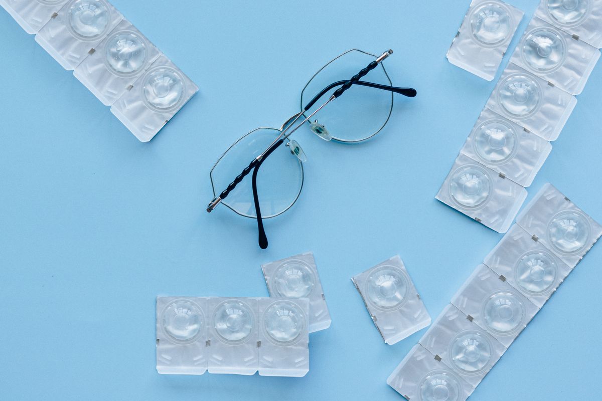 Reading glasses on an open book, showing how lens refraction helps magnify text