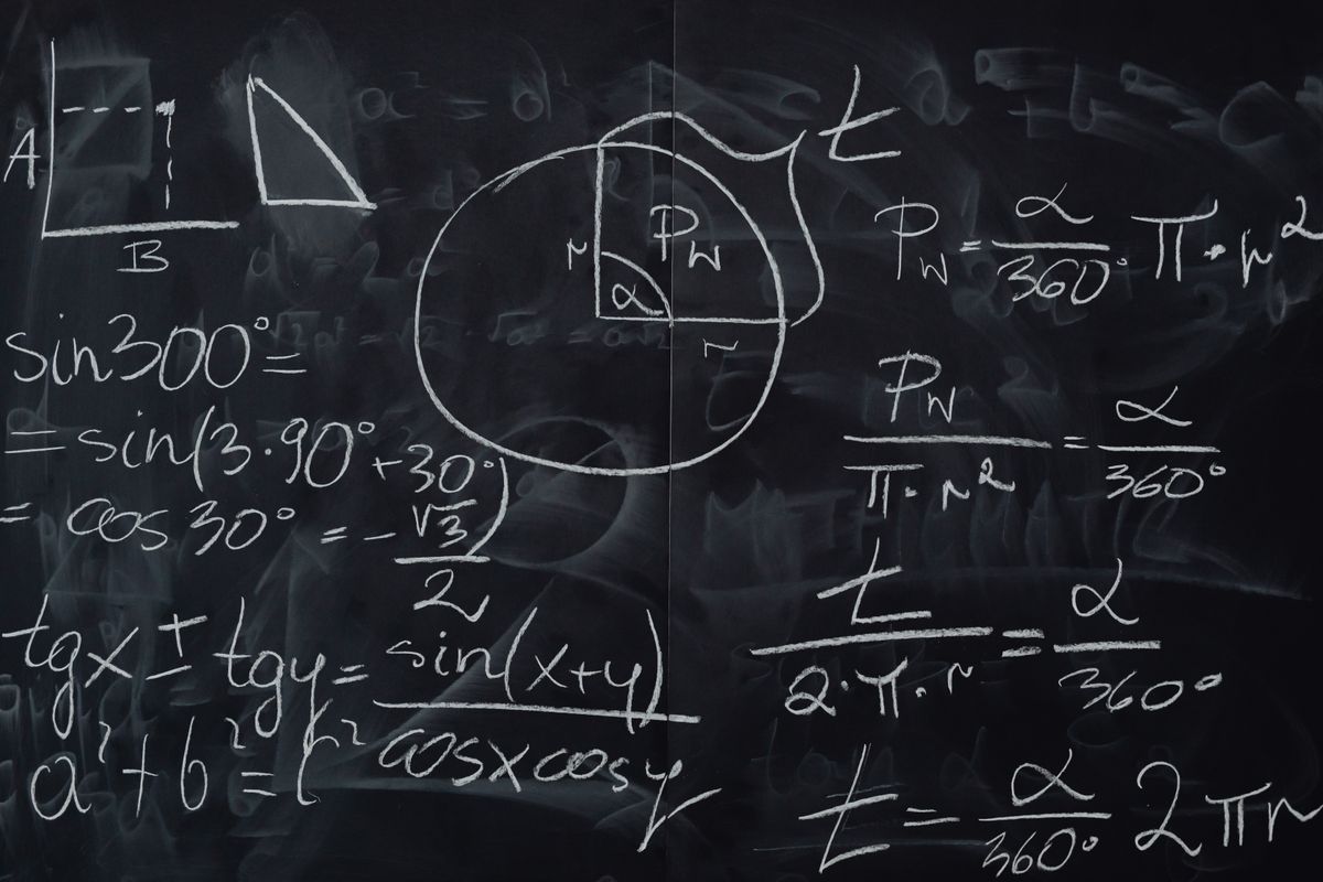 Optics formulas cheat sheet in practice: equations and diagrams worked out on a blackboard