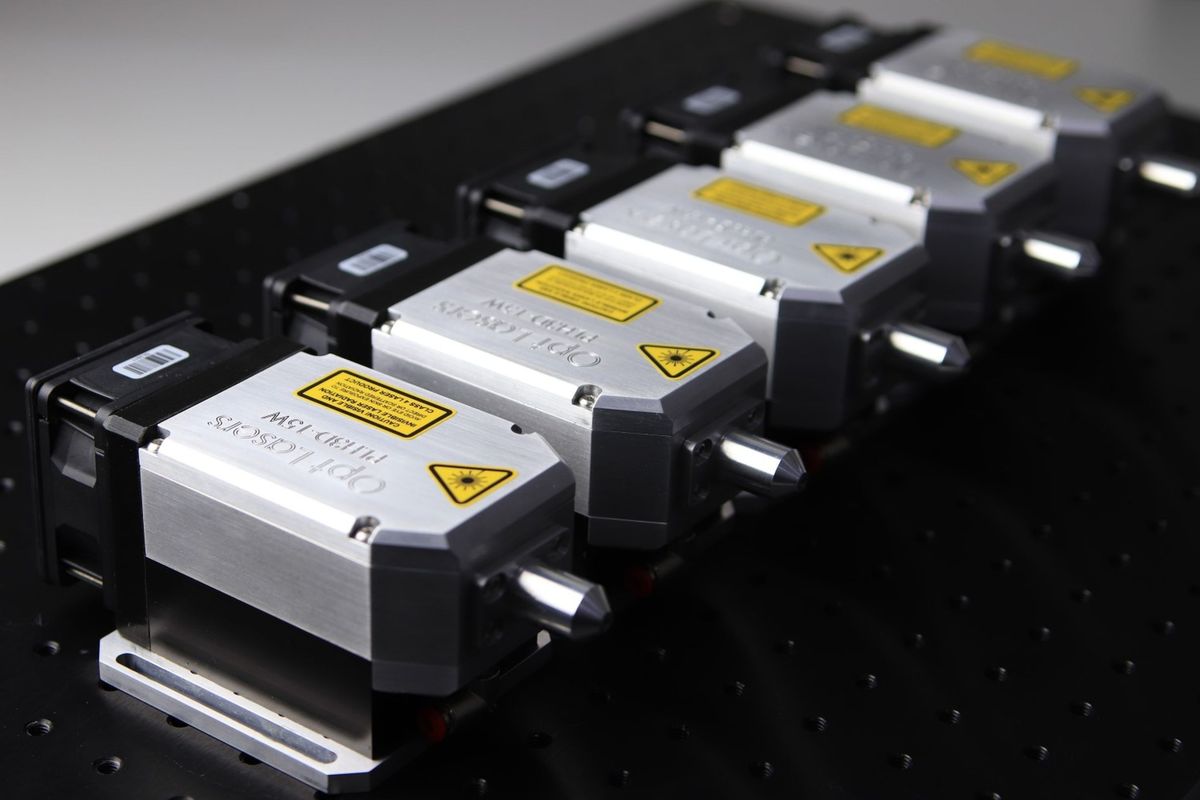 Close-up of aligned CNC laser modules showing the precision alignment required in laser construction