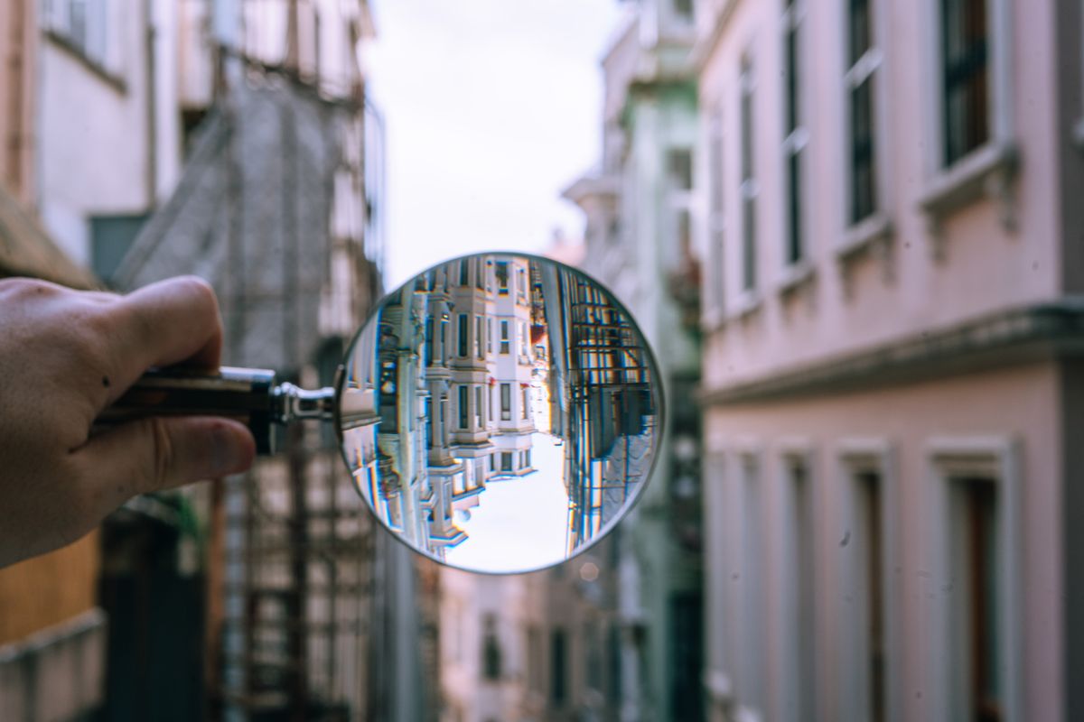 A magnifying glass bending light to form an image, a law of optics in action
