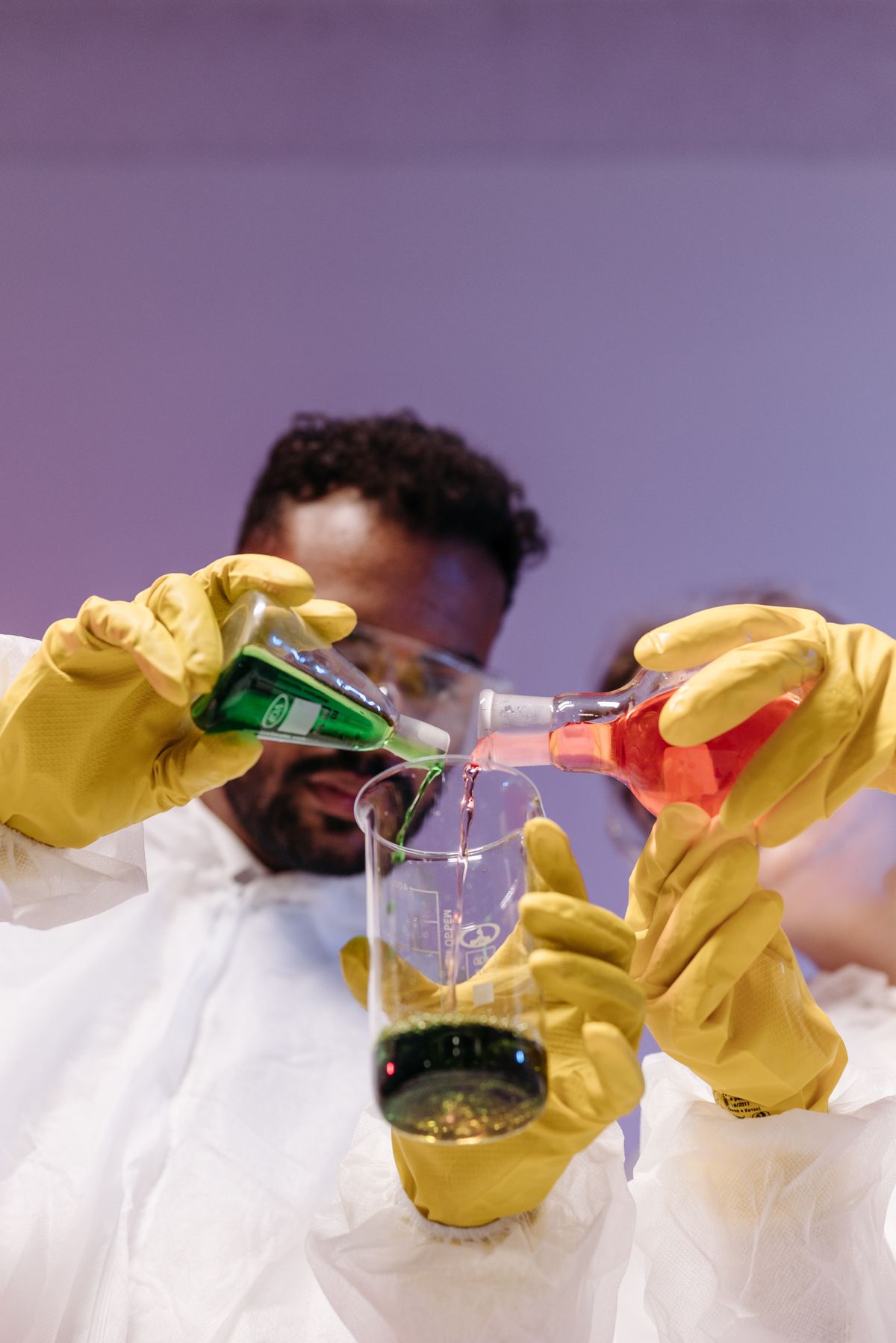 Optical density formula application: laboratory scientist in protective gear working with test tubes and samples for absorbance measurements