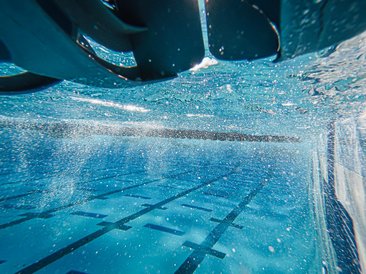 Sunlight bending through clear pool water, a everyday refraction example