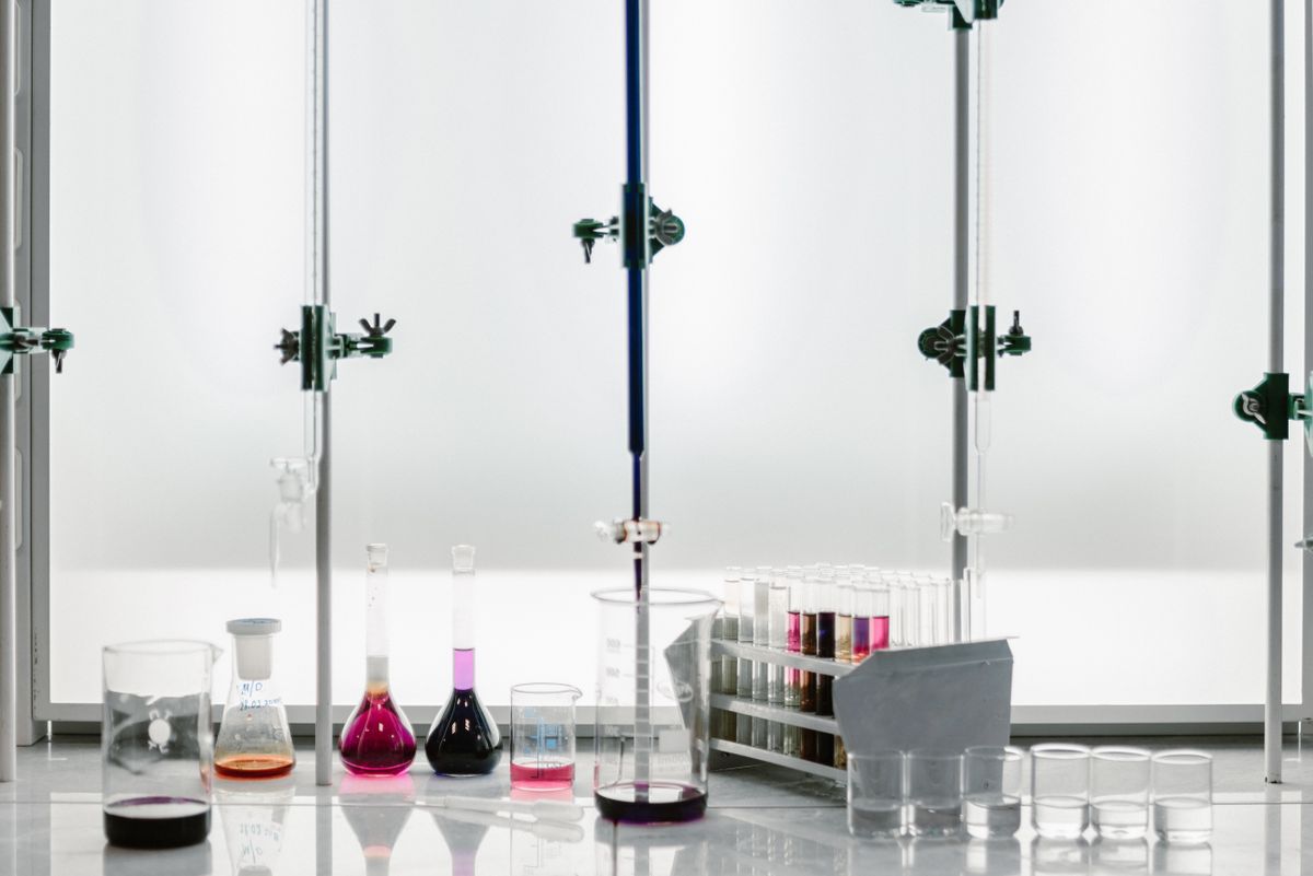 Optical rotation formula in the lab: glassware with chemical solutions used for polarimetry and optical activity measurements