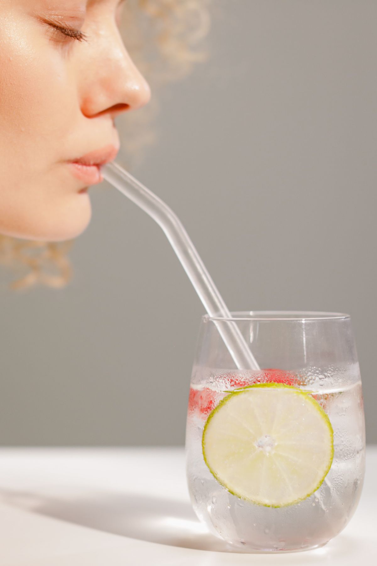 Straw in a glass of water appearing bent at the surface, demonstrating the refracted ray and apparent displacement